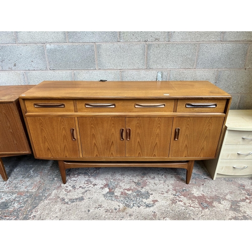 11 - A 1960s G Plan Fresco teak sideboard with three drawers and four cupboard doors