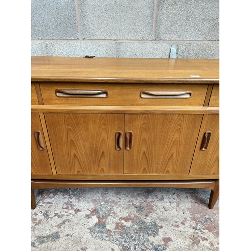 11 - A 1960s G Plan Fresco teak sideboard with three drawers and four cupboard doors