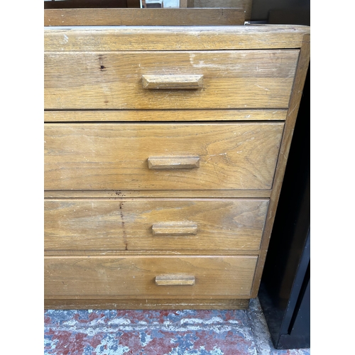 111 - A 1940s oak dressing chest with four drawers and upper mirror