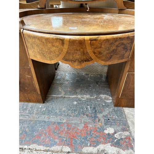 121 - An Art Deco style walnut dressing table with five drawers and upper mirror