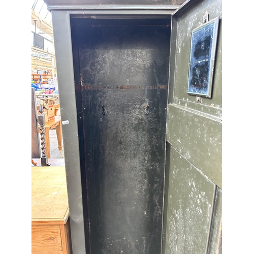 123 - A mid 20th century military green metal single door industrial locker - approx. 184cm high x 57cm wi... 