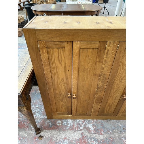 126 - A modern oak four door wall mountable cabinet