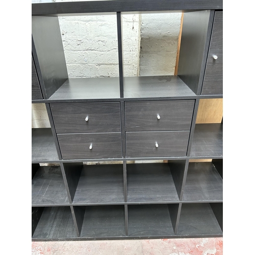 14 - A modern black ash effect cube shelving unit with four drawers and two cupboard doors