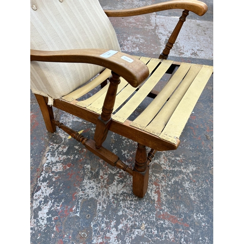 140 - A mid 20th century beech and fabric upholstered armchair