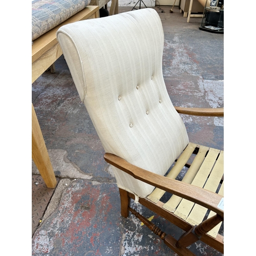 140 - A mid 20th century beech and fabric upholstered armchair