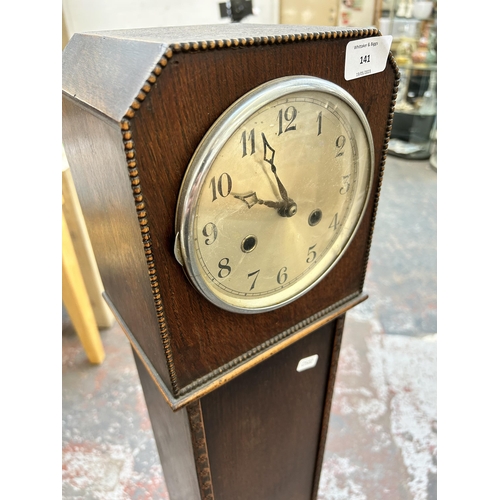 141 - A 1930s oak cased granddaughter clock