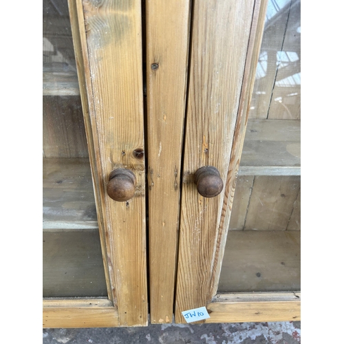 2 - A Victorian style pine wall hanging farmhouse display cabinet with two glazed doors