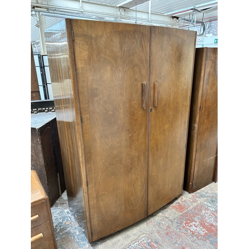 23 - An Austinsuite walnut three piece bedroom suite comprising two double wardrobes and dressing table