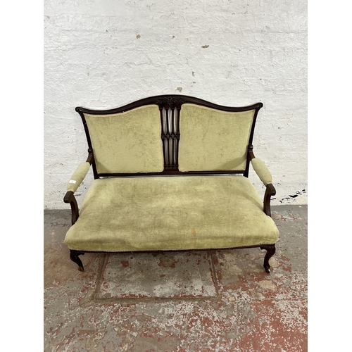 24 - An Edwardian carved mahogany and green fabric upholstered two seater parlour sofa with cabriole supp... 