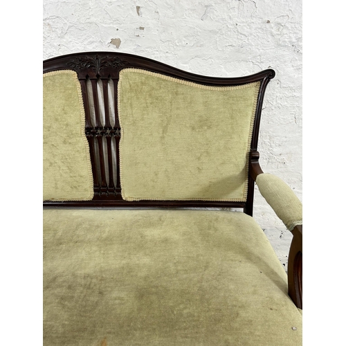 24 - An Edwardian carved mahogany and green fabric upholstered two seater parlour sofa with cabriole supp... 