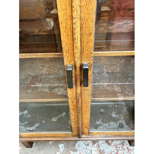 28 - An Art Deco oak bookcase with two glazed doors