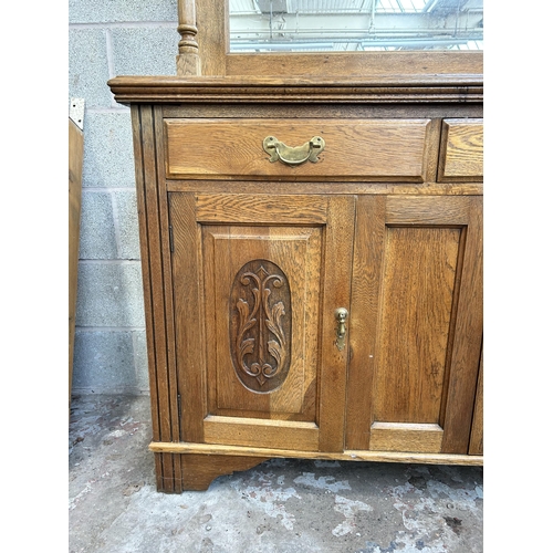 3 - An Arts and Crafts carved oak mirror back sideboard