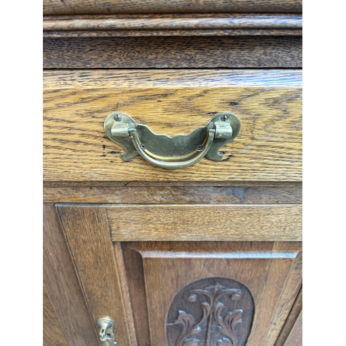 3 - An Arts and Crafts carved oak mirror back sideboard