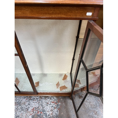 32 - A mahogany display cabinet with two glazed doors and bracket supports