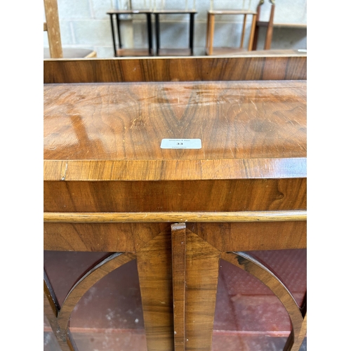 33 - A walnut display cabinet with two glazed doors and cabriole supports