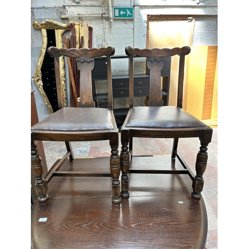 37 - A mid 20th century oak drop leaf gate leg oval dining table and four oak and brown leather dining ch... 