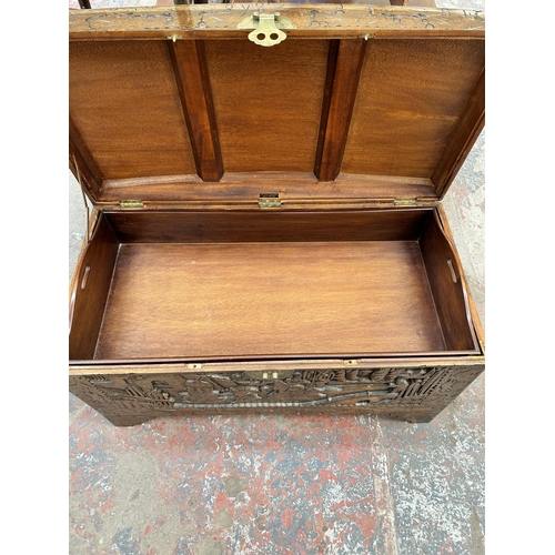 38 - A Chinese carved camphor wood blanket box with fitted interior