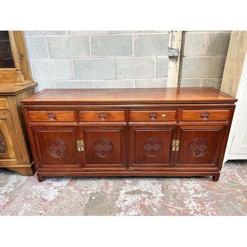 4 - A Chinese rosewood sideboard with four drawers and four cupboard doors