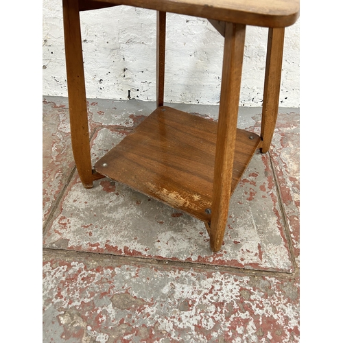 50 - A mid 20th century walnut two tier side table