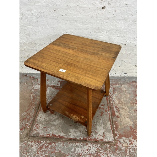 50 - A mid 20th century walnut two tier side table