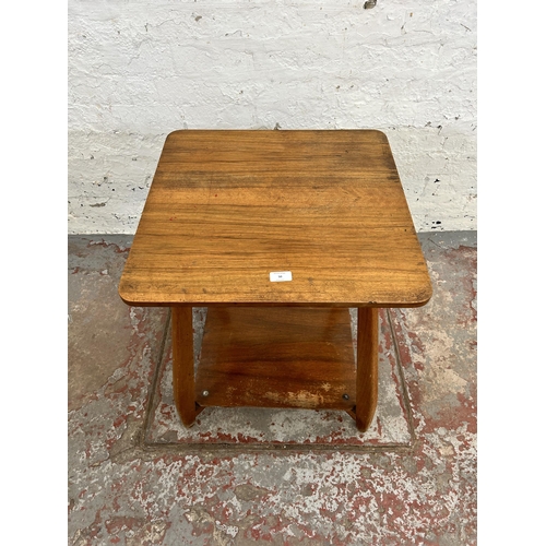 50 - A mid 20th century walnut two tier side table