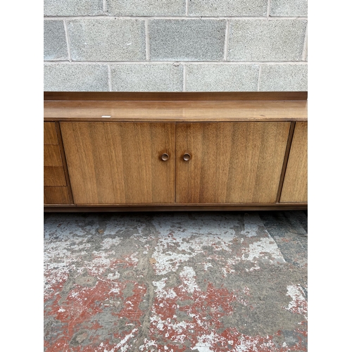 6 - A 1960s Meredew teak sideboard with four outer drawers, two cupboard doors and fall front