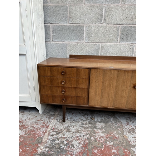 6 - A 1960s Meredew teak sideboard with four outer drawers, two cupboard doors and fall front