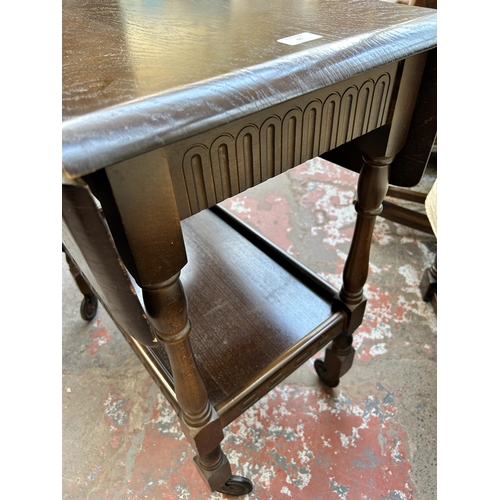 60 - A mid 20th century oak drop leaf two tier tea trolley