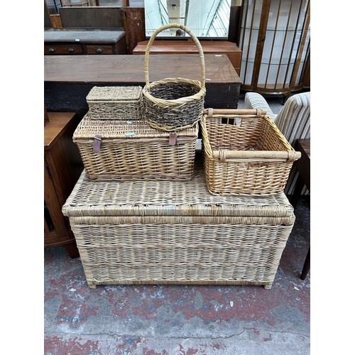 65 - Five pieces of wicker furniture, four baskets and one blanket chest