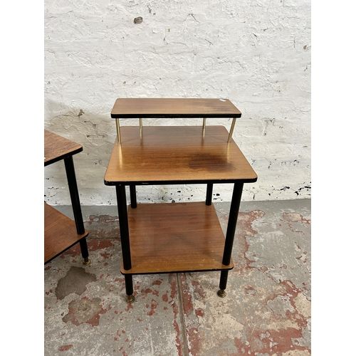 7 - A pair of mid 20th century teak and black painted two tier side tables