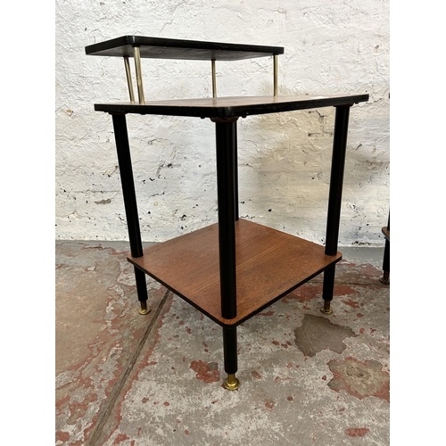 7 - A pair of mid 20th century teak and black painted two tier side tables