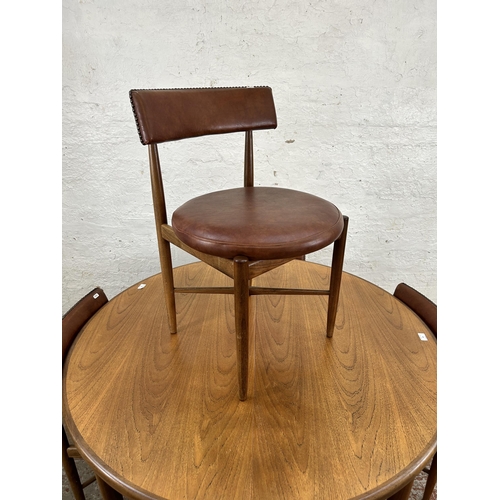 70 - A 1960s G Plan Fresco teak circular extending dining table and four dining chairs