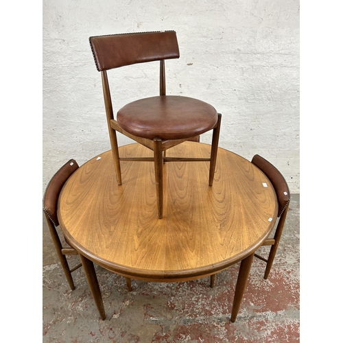 70 - A 1960s G Plan Fresco teak circular extending dining table and four dining chairs