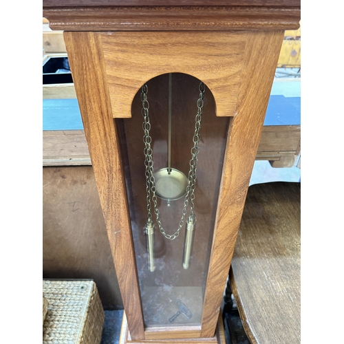 76 - An oak cased grandmother clock with brass Tempus Fugit face, pendulum, weights and key