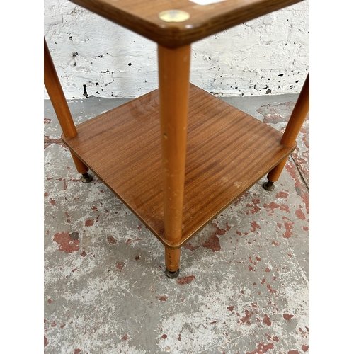 8 - A mid 20th century teak two tier side table