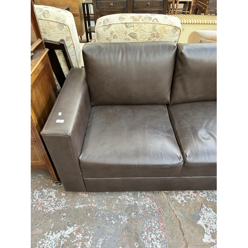 85 - A modern brown leatherette two seater sofa