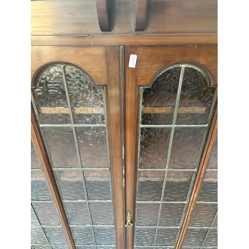 89 - An early 20th century mahogany bookcase top with two leaded glass doors