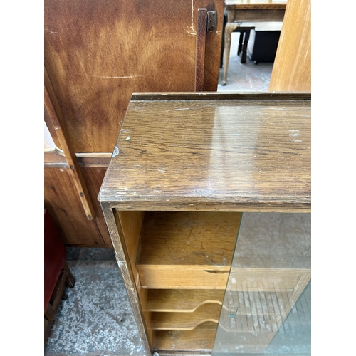 95 - A mid 20th century oak bookcase with two glass sliding doors and fitted interior