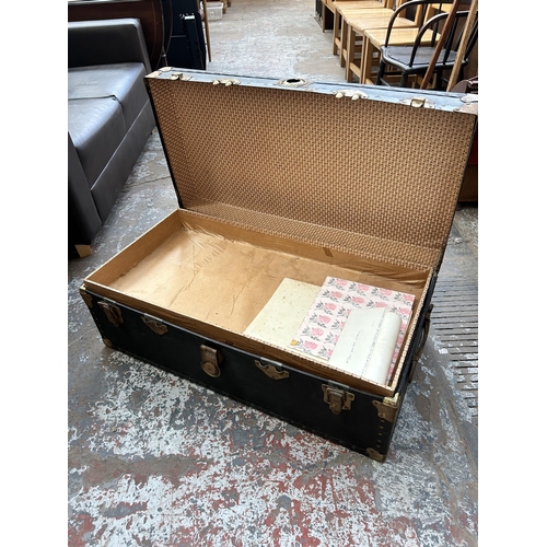 96 - An early 20th century black painted and brass travel trunk with internal tray