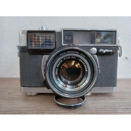 513 - A cased 1960s Fuji Fujica 35-EE auto/semi/manual exposure 35mm rangefinder camera fitted with Fujino... 