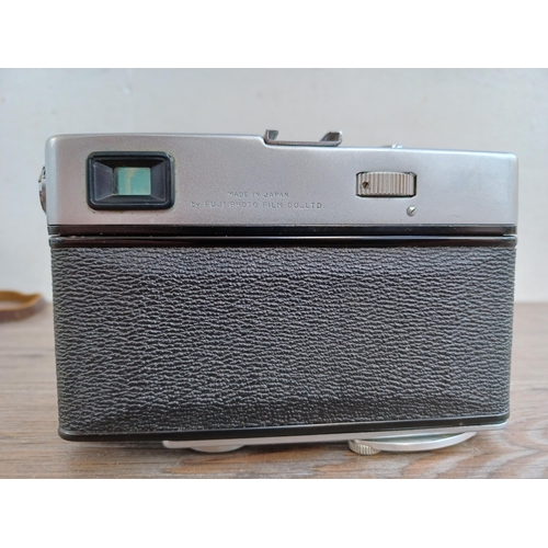 513 - A cased 1960s Fuji Fujica 35-EE auto/semi/manual exposure 35mm rangefinder camera fitted with Fujino... 