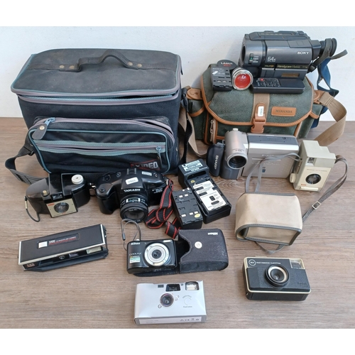 516 - Two camera cases containing cased Nikon Coolpix L25 compact digital camera, Sony CCD-TRV15E Handycam... 