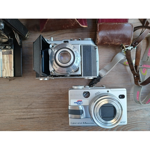 522 - A collection of items to include 1950s Kodak Retina Ia folding camera for 35mm film, Sony Cyber-shot... 