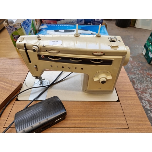 599 - A Singer sewing machine cabinet containing Singer 514 electric sewing machine with foot pedal, instr... 