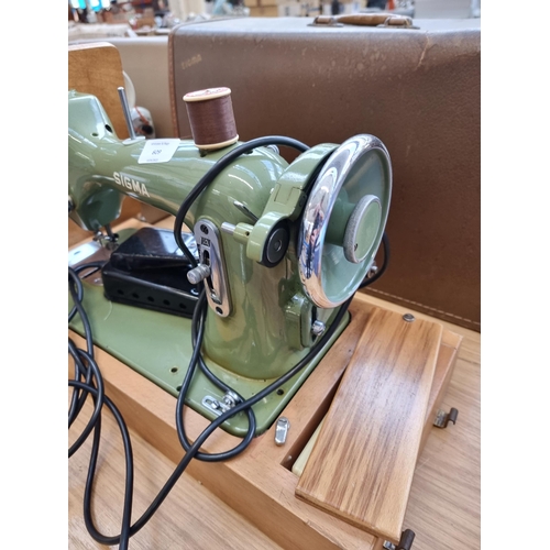 609 - A cased Sigma Model A electric sewing machine with power cable and foot pedal