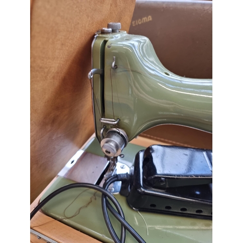 609 - A cased Sigma Model A electric sewing machine with power cable and foot pedal