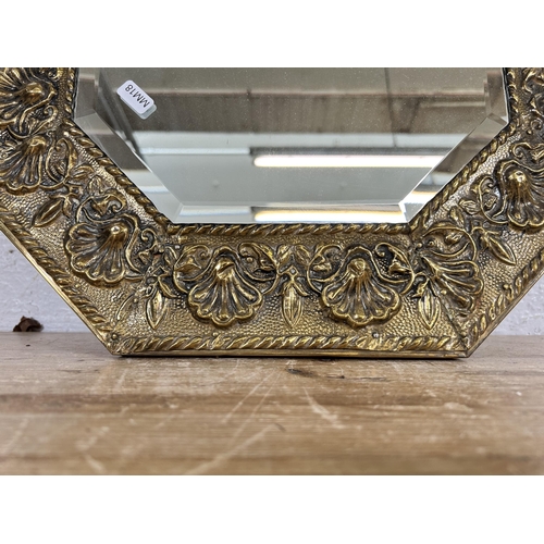 154 - An Art Deco style brass framed octagonal bevelled edge wall mirror - approx. 74cm x 44cm