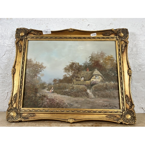 169 - A 20th century gilt framed oil on board of a cottage, signed Glynn Carter - approx. 39cm high x 50cm... 