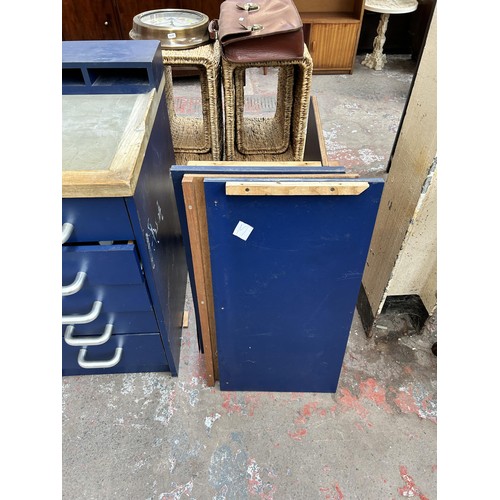 79 - A blue laminate and oak two piece watchmaker's work bench with ten drawers