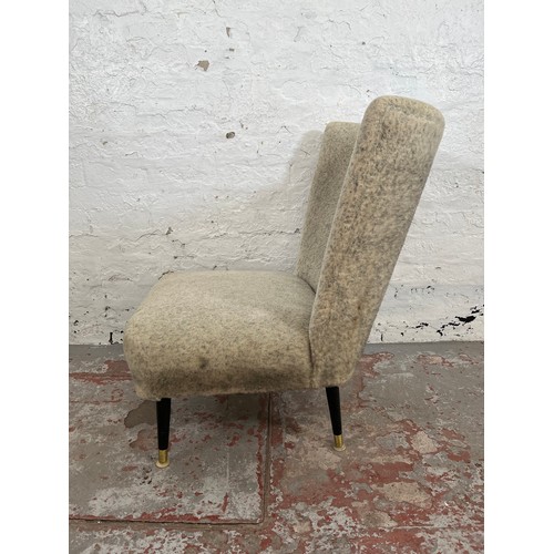 83 - A mid 20th century fabric upholstered lounge chair with black painted and brass splayed supports